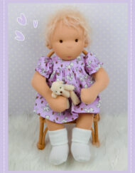 Baby Molly Doll Do Dah Waldorf Style Doll sitting in a chair.